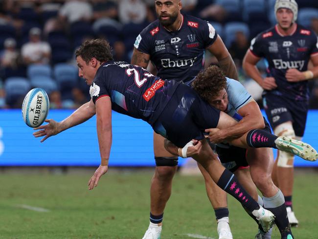 Waratahs' Mark Nawaqanitawase tackles Rebels' Nick Jooste during the Super Rugby match between the New South Wales Waratahs and Melbourne Rebels at Allianz Stadium in Sydney on March 29, 2024. (Photo by Saeed KHAN / AFP) / -- IMAGE RESTRICTED TO EDITORIAL USE - STRICTLY NO COMMERCIAL USE --