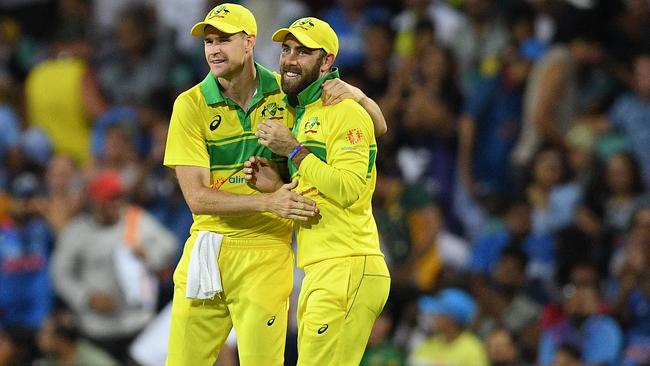 Jason Behrendorff and Glenn Maxwell celebrate a wicket.