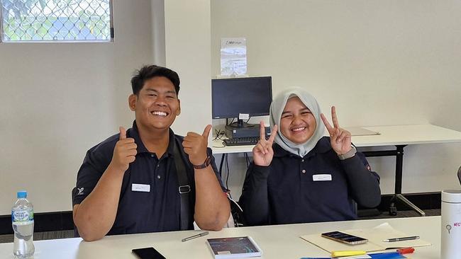 Dzulkarnain Bin Abdul Rahim and Nur Aisyah Binti Anuar giving the thumbs up to their regional learning experience.