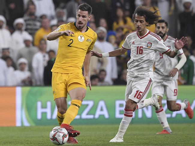 Australia’s defender Milos Degenek, left, makes a wrong pass to his goalkeeper Mat Ryan as United Arab Emirates’ midfielder Mohammed Abdulrah, right, looks on during the AFC Asian Cup quarter-final. Picture: AP Photo/Hassan Ammar