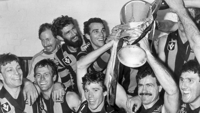 Russell Greene (second left) celebrates the 1983 grand final with teammates, including Michael Tuck and Leigh Matthews.