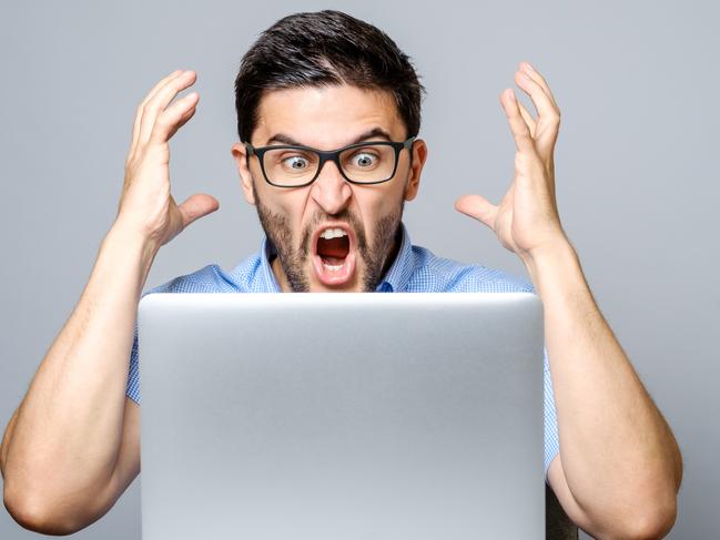 An angry man using his computer. Picture: iStock.