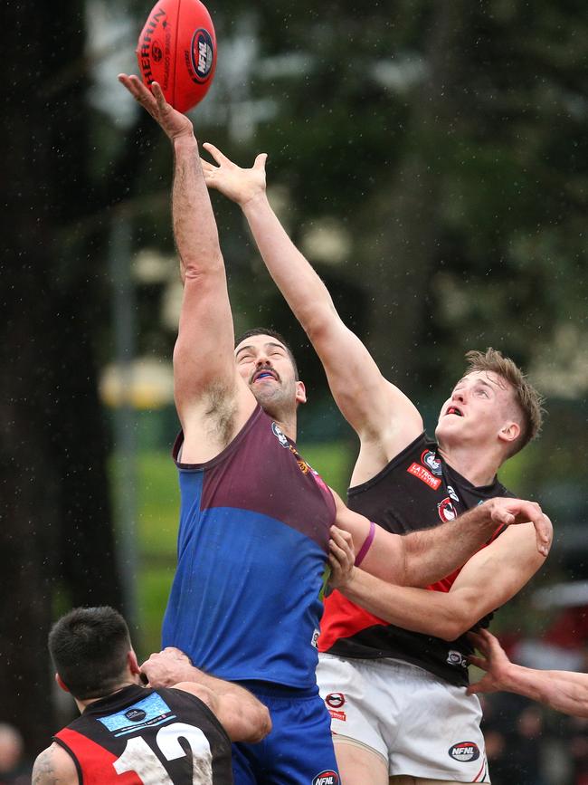 NFL: Banyule’s Tim Martin wins a ruck contest over David Evans of Eltham. Picture: Hamish Blair