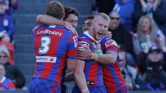 NEWCASTLE, AUSTRALIA — JULY 21: Mitch Barnett of the Knights celebrates his try with teammates during the round 19 NRL match between the Newcastle Knights and the Gold Coast Titans at McDonald Jones Stadium on July 21, 2018 in Newcastle, Australia. (Photo by Ashley Feder/Getty Images)