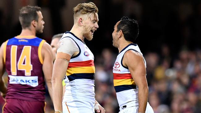 Hugh Greenwood celebrates his first goal in AFL footy with Eddie Betts who gifted it to him in 2017. Picture: Bradley Kanaris (Getty)