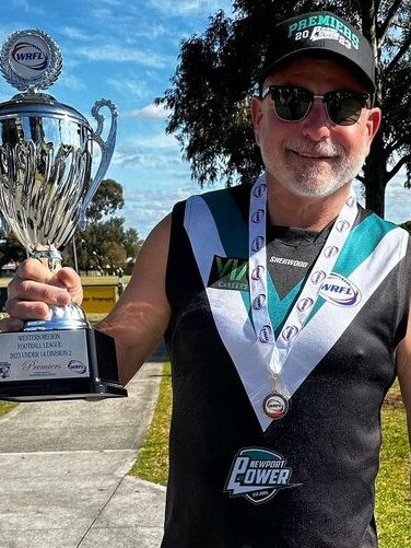 Coach Sean Adams with the Under 14s premiership cup.