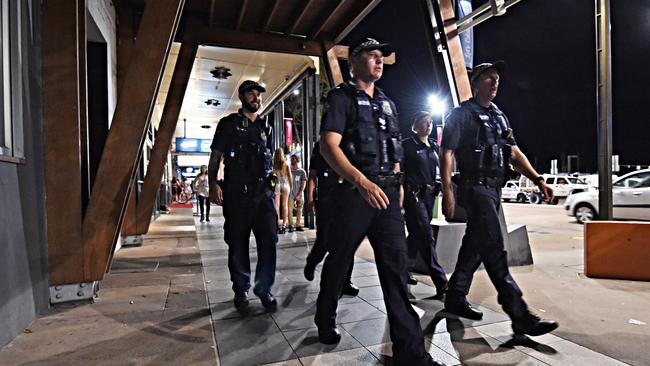 Police walk down Flinders Street as they patrol on a night out. Picture: Zak Simmonds