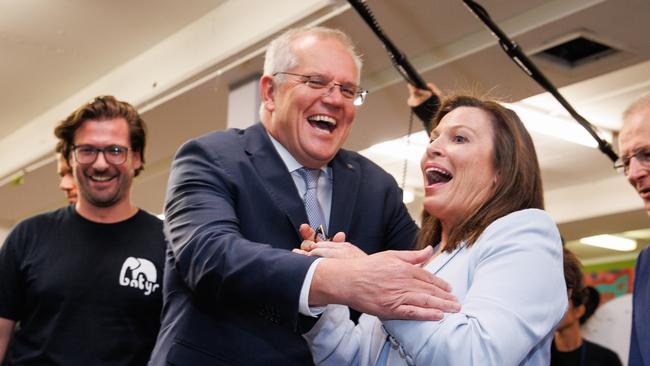 The PM and Jenny play a ball game where she misses the first few shots and they laugh together at an event hosted by batyr in Parramatta. Picture: Jason Edwards