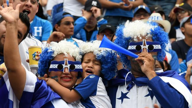 Supporters of Honduras cheer during the first leg football match.