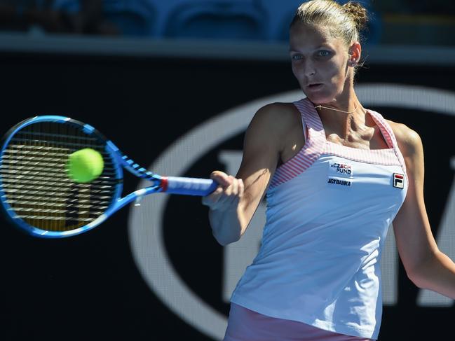 Czech Republic's Karolina Pliskova hits a return against Spain's Garbine Muguruza.