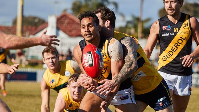 Glenelg’s Marlon Motlop is tackled by Woodville-West Torrens’ Jack Firns during the SANFL thriller at Woodville Oval. Picture: Matt Loxton