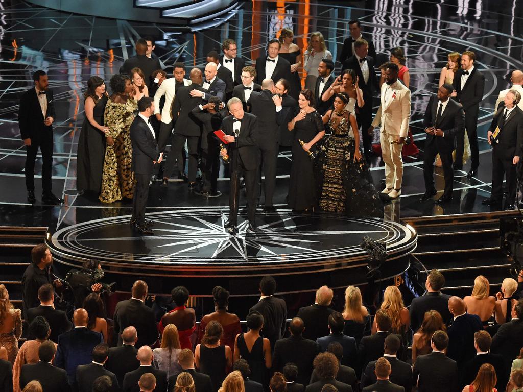 The cast of “Moonlight” and “”La La Land” appear on stage as presenter Warren Beatty (, flanked by host Jimmy Kimmel shows the winner’s envelope for Best Movie “Moonlight” on stageduring the 89th Annual Academy Awards. Picture: AFP