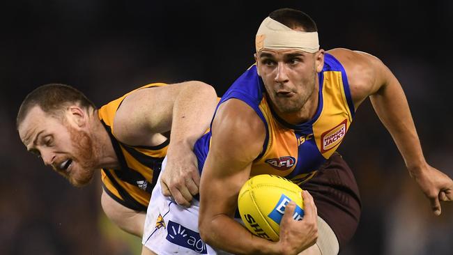 Hawthorn’s Jarryd Roughhead, left, and West Coast’s Dom Sheed at Etihad Stadium yesterday. Picture: AAP.