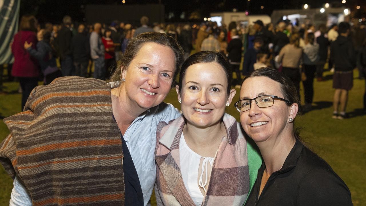 At the Symphony Under the Stars concert performed by the Queensland Symphony Orchestra are (from left) Olivia Raeburn, Alicia Raeburn and Danae O'Keeffe in Queens Park Amphitheatre for Carnival of Flowers, Friday, October 4, 2024. Picture: Kevin Farmer