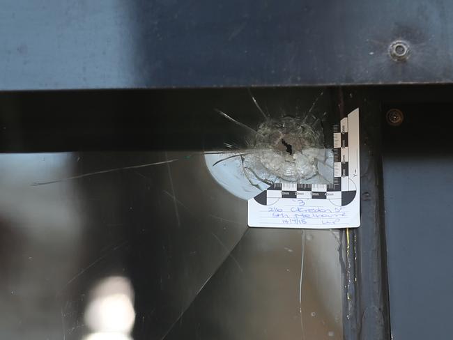 Two bullet holes in the tattoo parlour. Picture: David Crosling