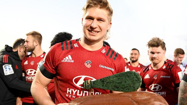 Jack Goodhue of the Crusaders with the wooden trophy.