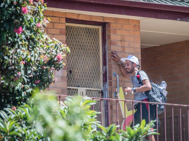 A man waits outside the apartment last month. Picture: Jason Edwards