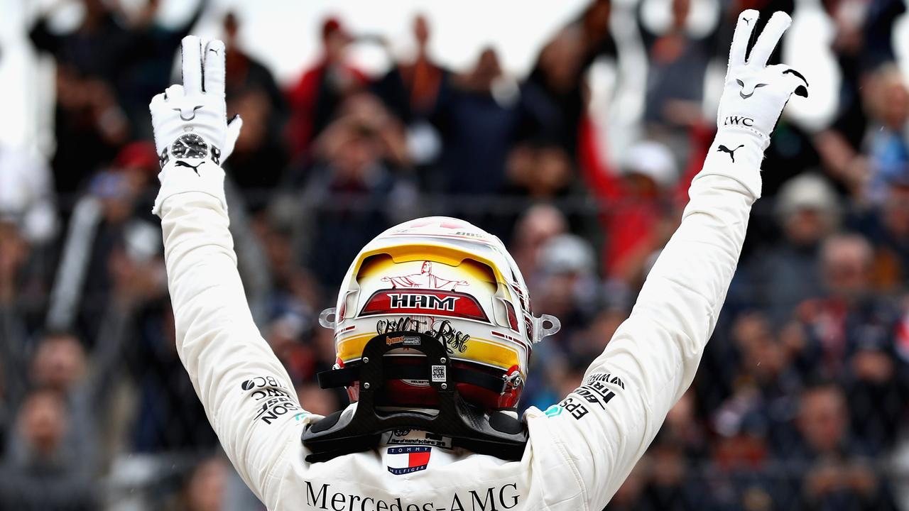 Pole position qualifier Lewis Hamilton of Great Britain and Mercedes GP celebrates in parc ferme during qualifying for the United States Formula One Grand Prix at Circuit of The Americas.