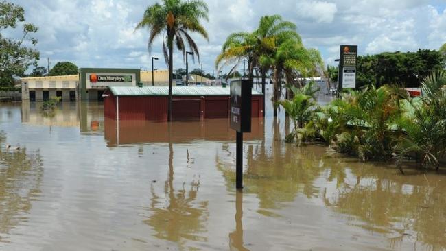 Dan Murphy’s on Targo Street in floodwaters, 2013. A stark depiction of the flood’s impact on businesses. Photo: Mike Knott, NewsMail