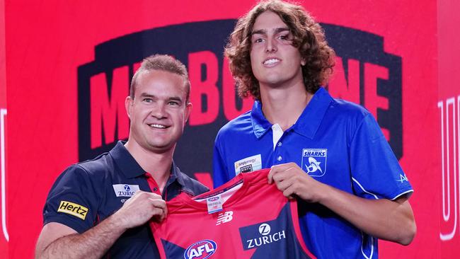 Luke Jackson is presented with his Melbourne jumper by Brad Green. Picture: AAP