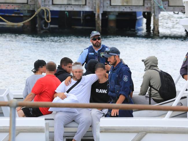 Passengers on a police boat take a ride to shore at Eden, NSW.