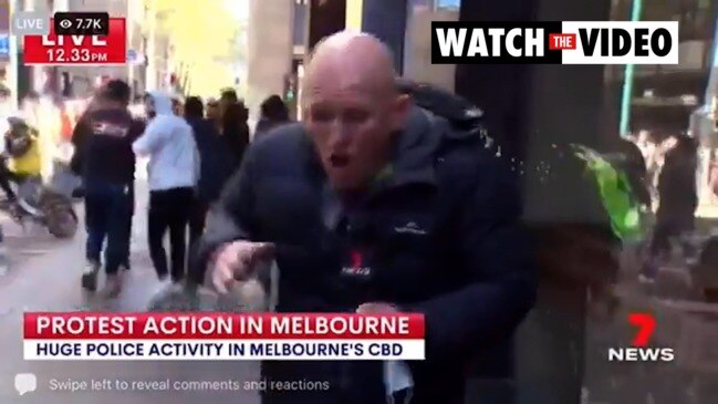 The moment Channel 7 reporter is hit with drink can (7 News)