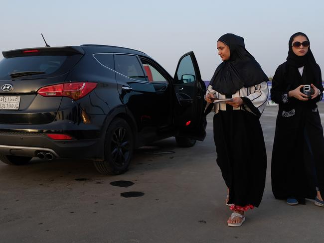 Women leave a station where she sat in a car while an instructor demonstrated a parking technique during an outdoor educational driving event for women. Pic: Getty