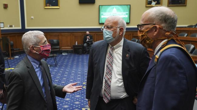 Director of the National Institute of Allergy and Infectious Diseases Dr. Anthony Fauci, (L) speaks with Dr. Robert Redfield, director of the Centers for Disease Control and Prevention (C). Picture: AP.