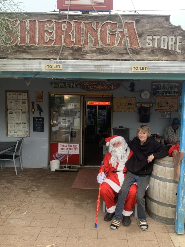 Kathy & Mark Keogh proudly sit outside Sheringa Roadhouse, where they’ve been since the 90s after swapping city life for the quietness of the outback.