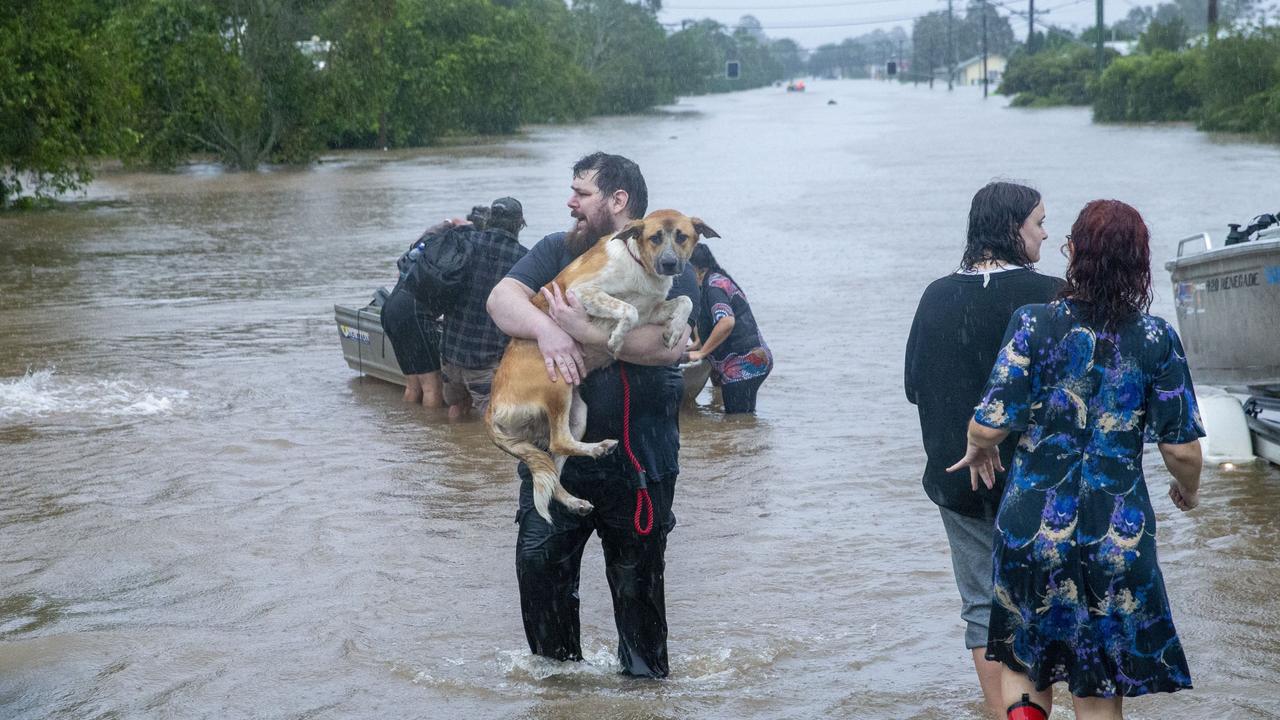 Residents wade through flood waters in Lismore. Picture: MEDIA-MODE.COM