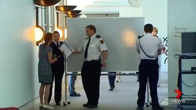 Michaelia Cash is shielded from media by a whiteboard.