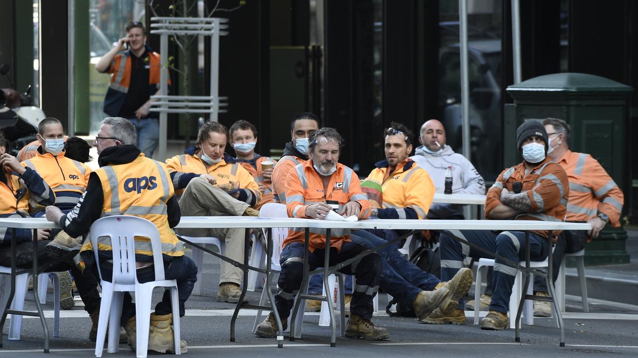 Construction workers enjoy their smoko in the middle of the intersection of A'Beckett and Elizabeth streets in central Melbourne. Picture: NCA NewsWire / Andrew Henshaw