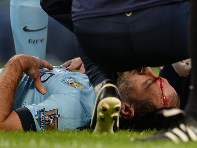 Manchester City's Argentinian defender Pablo Zabaleta receives treatment for a head injury.