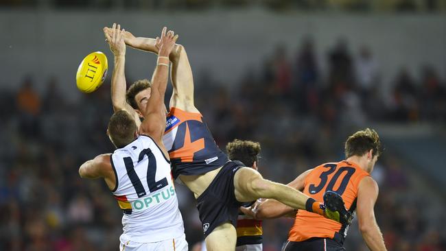 Daniel Talia seeks to spoil GWS forward Jeremy Cameron in Canberra on Friday night. Picture: Lukas Coch/AAP