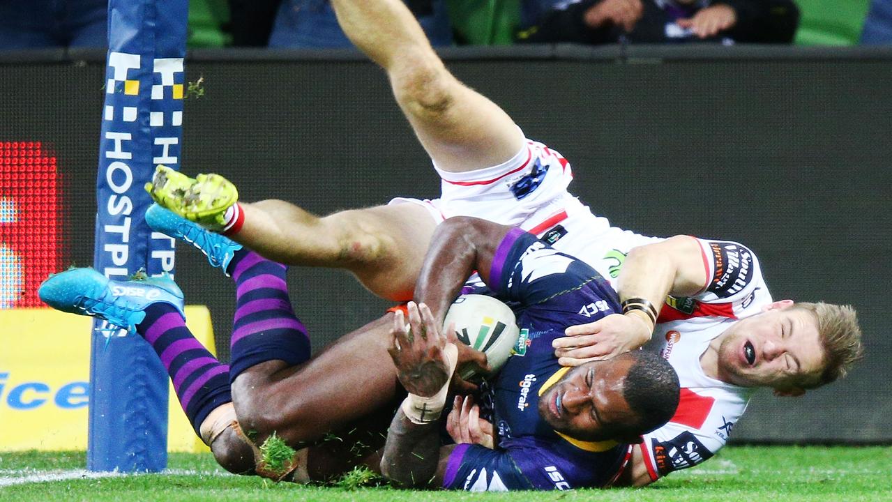 Suliasi Vunivalu of the Storm scores a try past Matt Dufty of the Dragons. Picture: Getty Images