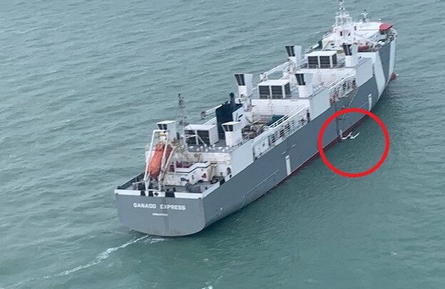 The livestock vessel the Ganado Express found two Darwin sailors who spent the night clinging to their capsized catamaran. Their vessel is circled. Pictures: NT Police