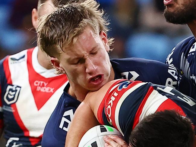 SYDNEY, AUSTRALIA - JUNE 02: Joseph Manu of the Roosters is tackled by Jaxon Purdue and Jordan McLean  of the Cowboys during the round 13 NRL match between Sydney Roosters and North Queensland Cowboys at Allianz Stadium, on June 02, 2024, in Sydney, Australia. (Photo by Jeremy Ng/Getty Images)