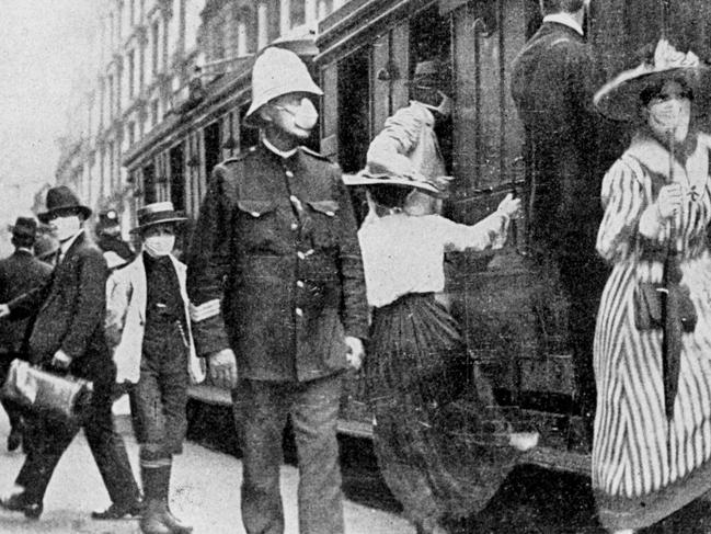 Masks were made mandatory on the streets of some Australian cities at the height of the Spanish Flu epidemic in 1919. Commuters and a policeman in Sydney pictured above.