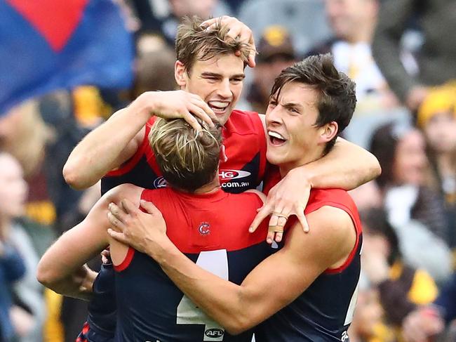 MELBOURNE, AUSTRALIA - AUGUST 06: Dom Tyson of the Demons celebrates with Jack Watts and Sam Weideman of the Demons of the Demons after kicking a goal inthe final quarter during the round 20 AFL match between the Melbourne Demons and the Hawthorn Hawks at Melbourne Cricket Ground on August 6, 2016 in Melbourne, Australia. (Photo by Scott Barbour/Getty Images)