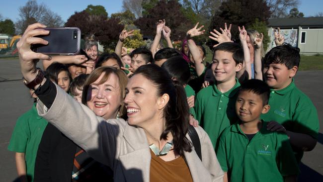 Look at me: Jacinda Ardern masters the art of the selfie. Picture: AP