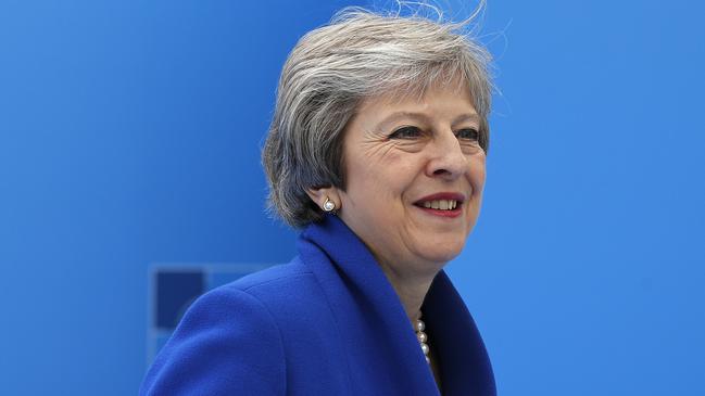 British Prime Minister Theresa May smiles as she arrives for a summit of heads of state and government at NATO headquarters in Brussels on Wednesday, July 11, 2018. NATO leaders gather in Brussels for a two-day summit to discuss Russia, Iraq and their mission in Afghanistan. (AP Photo/Francois Mori)