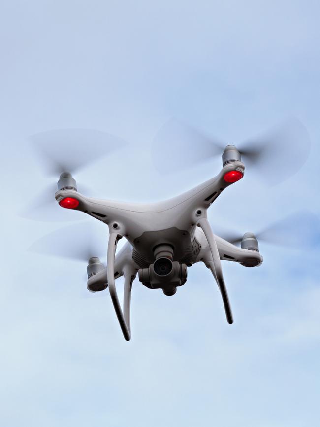 Noirmoutier, France - July 27 2017: Close-up on a white quadcopter drone hovering in a cloudy sky above the Passage du Gois in Vendée. Because of the 4k camera and the gimbal used for stability, this kind of drone is ideal for aerial photography and stunning videos.