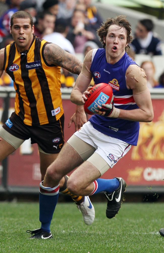 Ayce Cordy running away from Hawthorn’s Lance Franklin.