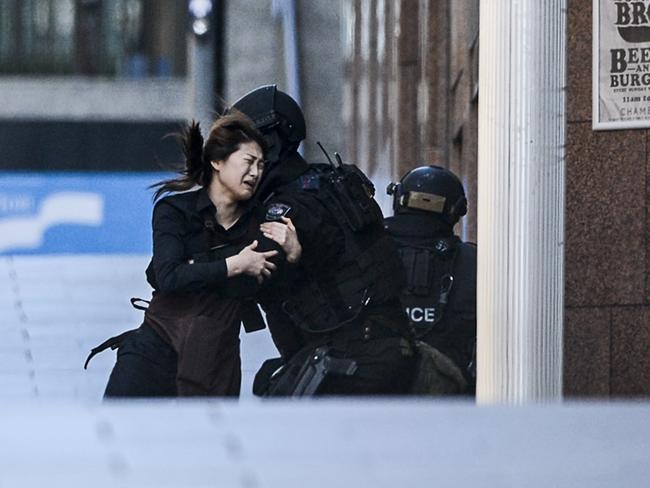 A hostage runs from the Lindt Cafe. Picture: Chris McKeen