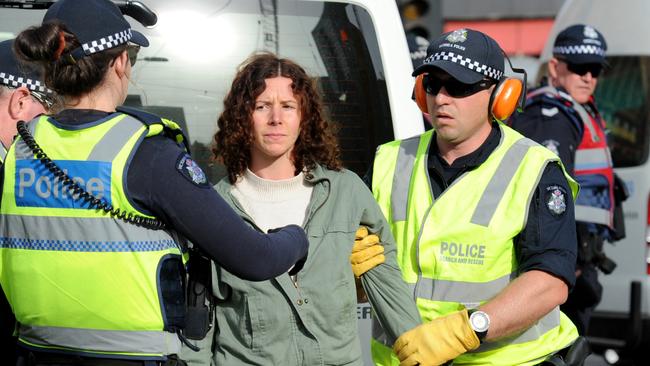 Police remove a vegan protestor who had been blocking the intersection of Flinders and Swanston Street, Melbourne in support of animal rights. Picture: Andrew Henshaw