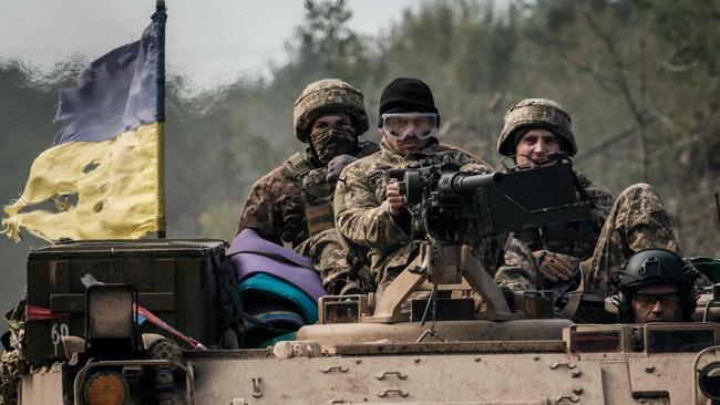 Ukrainian soldiers ride on an armoured vehicle near the recently retaken town of Lyman in Donetsk region. Picture: AFP