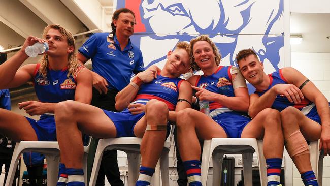 Bailey Smith, left, takes a drink in the rooms after the Bulldogs’ 2022 Round 3 win against Sydney, alongside Adam Treloar, Cody Weightman and Josh Dunkley.