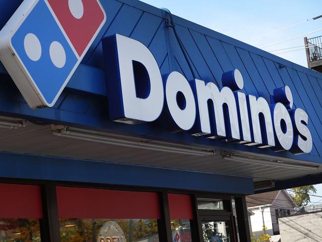 CHICAGO, ILLINOIS - OCTOBER 14: A sign hangs above the entrance of a Domino's restaurant on October 14, 2022 in Chicago, Illinois. Domino's, America's largest pizza chain, reported a rise in third quarter sales of 2% in the U.S. and revenue growth of 7.1 percent.   Scott Olson/Getty Images/AFP