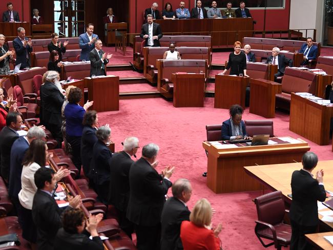 Senators applaud George Brandis for his criticism of Pauline Hanson. Picture: AAP