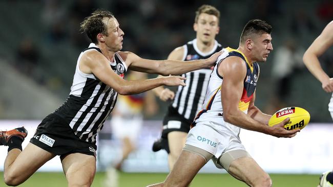 Port Adelaide’s Cam Sutcliffe tackles Adelaide’s Patrick Wilson. Picture: Sarah Reed.